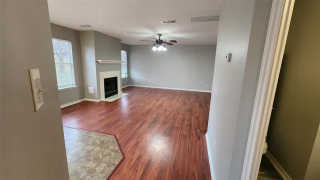 wooden floor in an empty room with a fireplace