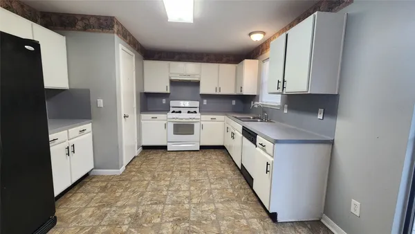 a kitchen with stainless steel appliances sink a microwave and cabinets