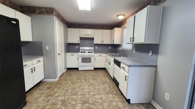 a kitchen with stainless steel appliances sink a microwave and cabinets