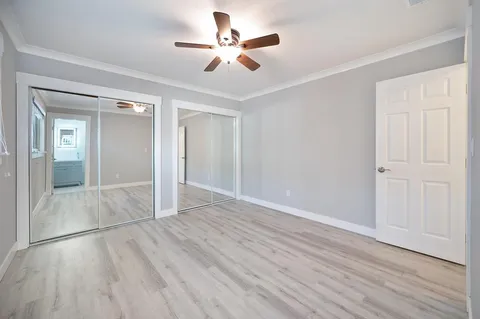 a view of empty room with wooden floor