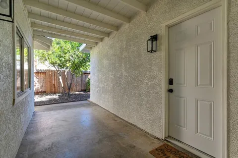 a view of a room with wooden floor and a porch
