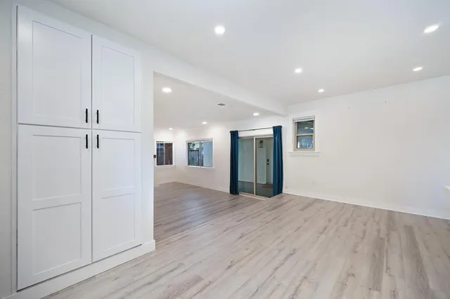 a view of an empty room with wooden floor