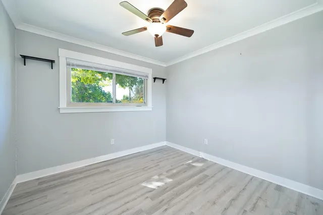 wooden floor in an empty room with a window