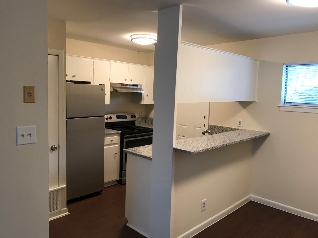 5001 Bull Creek Road, Unit 108 Austin, TX 78731 - Photo 11 of 21 a kitchen with kitchen island a sink appliances and cabinets