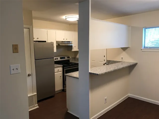 a kitchen with a refrigerator and a sink
