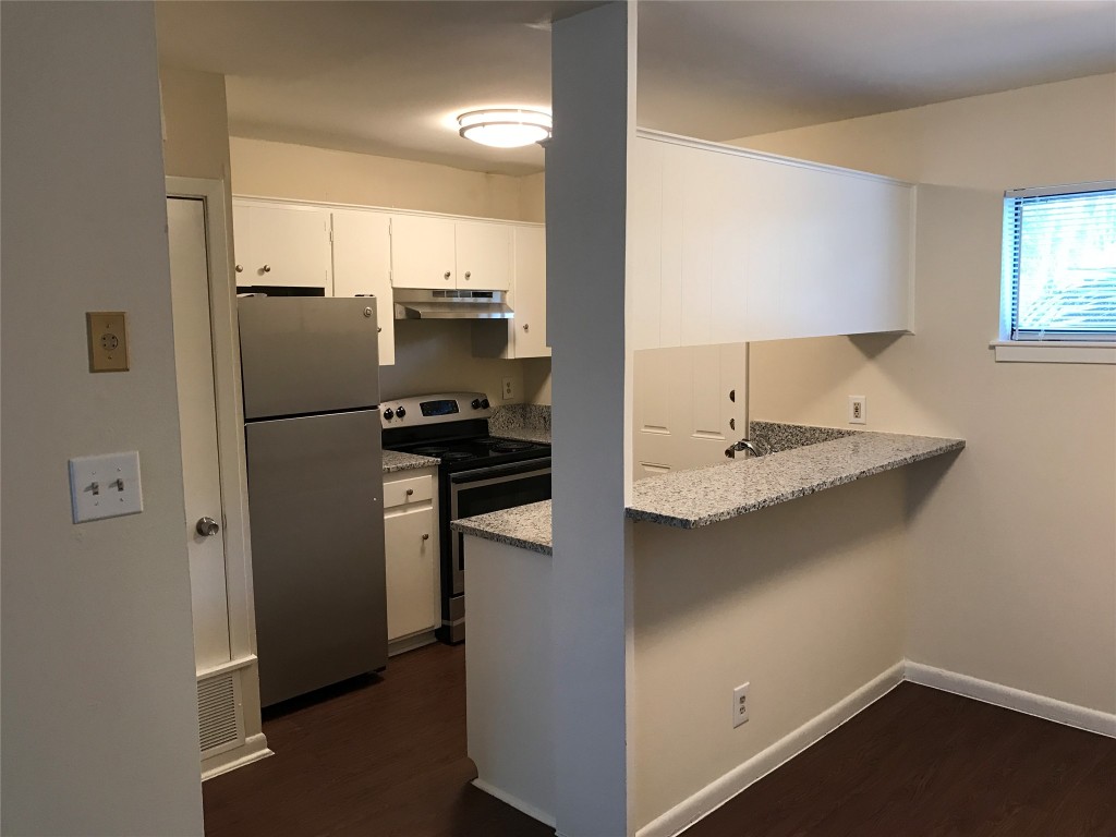 5001 Bull Creek Road, Unit 108 Austin, TX 78731 - Photo 12 of 21 a kitchen with a refrigerator and a sink