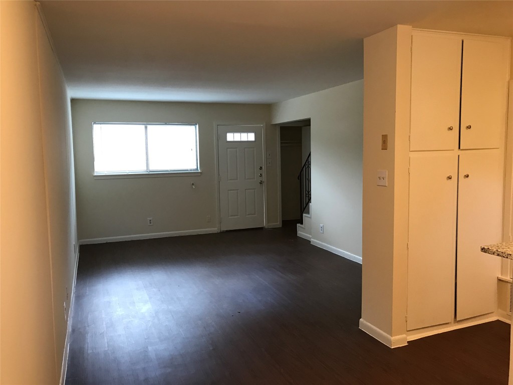 5001 Bull Creek Road, Unit 108 Austin, TX 78731 - Photo 14 of 21 a view of an empty room with wooden floor and a window