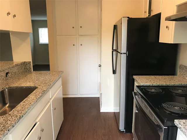 a kitchen with stainless steel appliances granite countertop a refrigerator and a sink