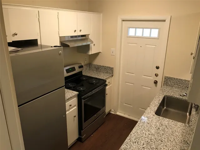 a kitchen with a refrigerator stove and sink