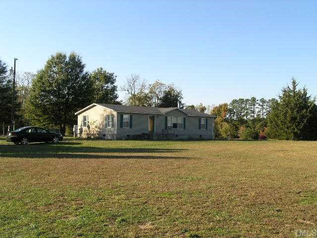 998 Bobbitt Road Kittrell, NC 27544 - Photo 3 of 4 a front view of a house with a garden and trees