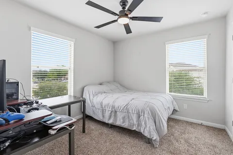 a bedroom with a bed and a window