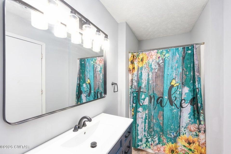 524 South Main Street Ridgely, TN 38080 - Photo 12 of 23 a bathroom with a bathtub and a sink