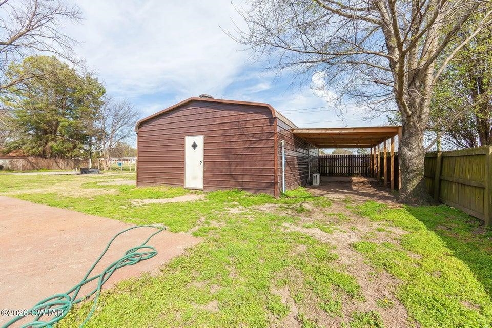 524 South Main Street Ridgely, TN 38080 - Photo 21 of 23 a backyard of a house with a garden and barbeque oven
