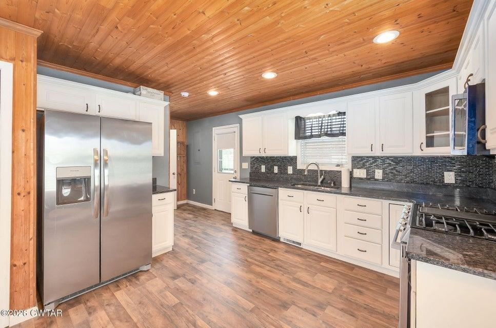 524 South Main Street Ridgely, TN 38080 - Photo 5 of 23 a kitchen with granite countertop a refrigerator and a stove top oven