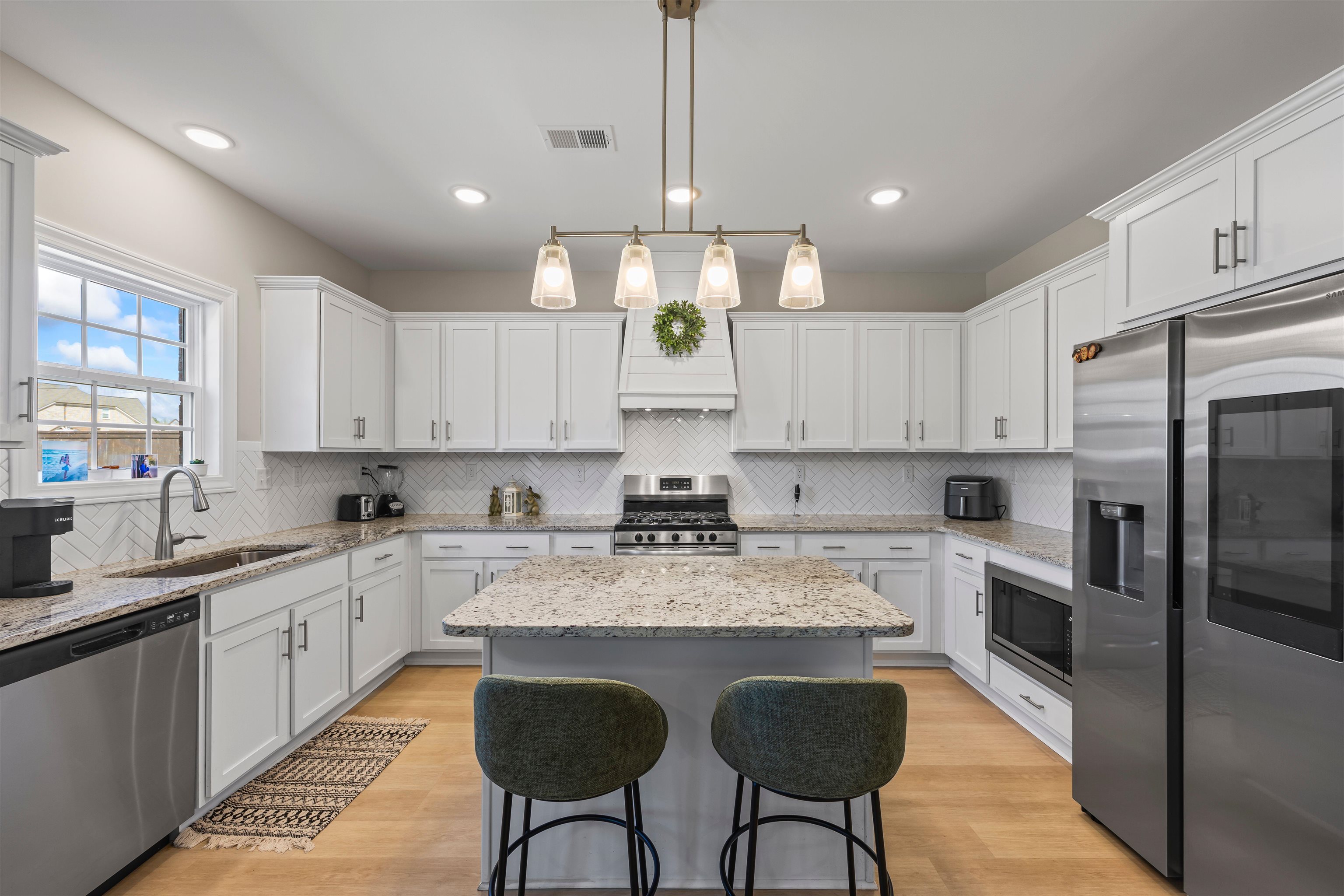 524 South Main Street Ridgely, TN 38080 - Photo 6 of 23 a kitchen with stainless steel appliances granite countertop a stove top oven a refrigerator a sink and white cabinets