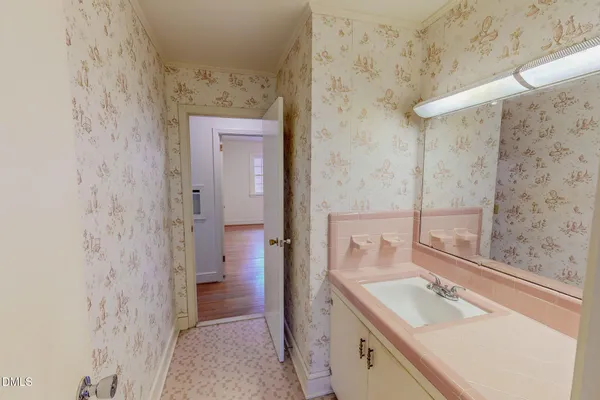 a bathroom with a granite countertop shower a sink and a mirror