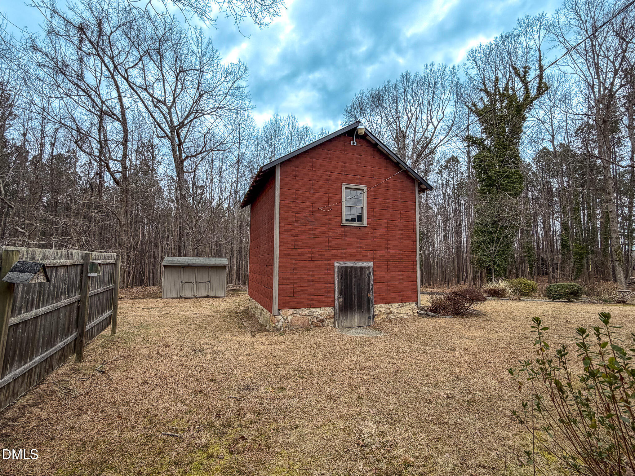 333 Allensville Road Roxboro, NC 27574 - Photo 7 of 43 a backyard of a house with fire pit and trees