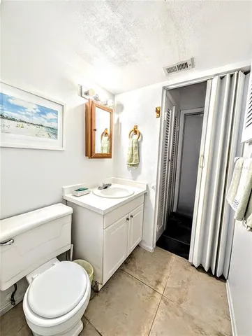 a bathroom with a sink a toilet a mirror and shower