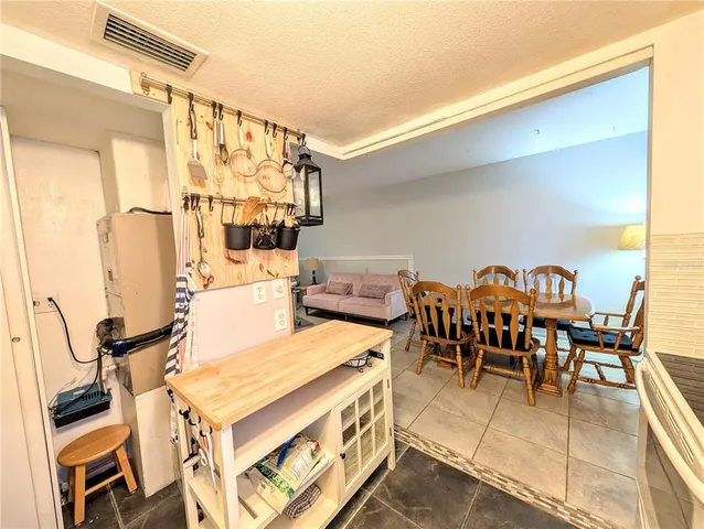 a living room with chairs a dining table and chairs