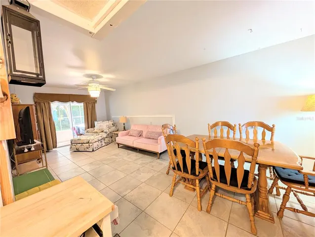 a living room with furniture a rug and a painting on the wall