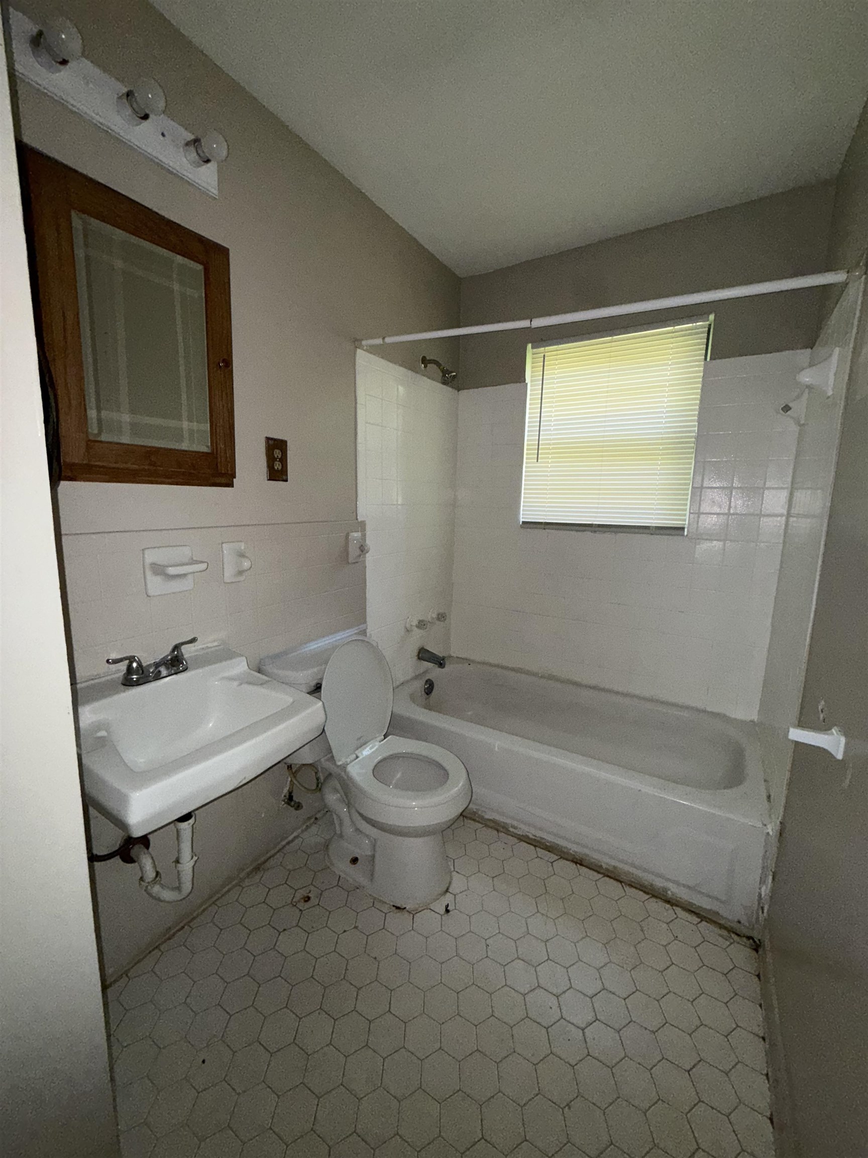 820 Archie Drive Memphis, TN 38127 - Photo 8 of 11 a bathroom with a granite countertop sink toilet a mirror and bathtub