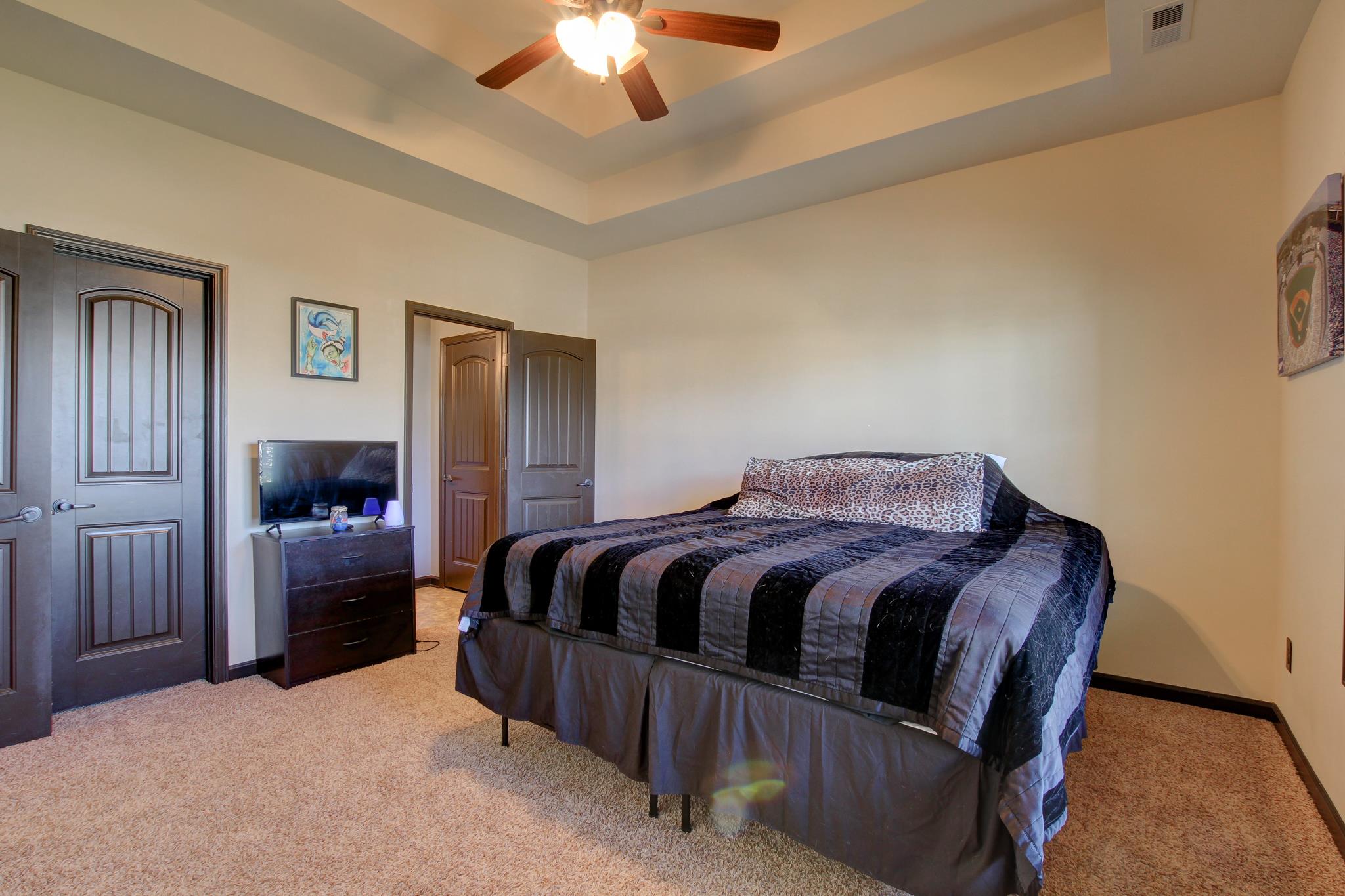 3736 Suiter Road Clarksville, TN 37040 - Photo 12 of 21 a spacious bedroom with a bed and a chandelier