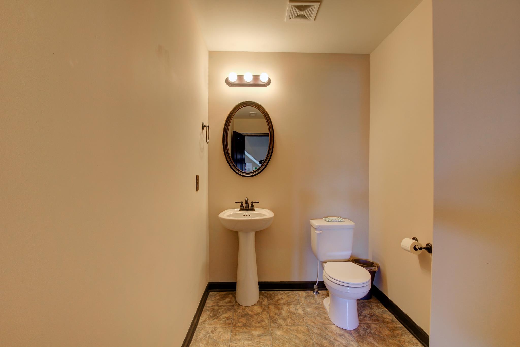 3736 Suiter Road Clarksville, TN 37040 - Photo 15 of 21 a bathroom with a toilet a sink and mirror