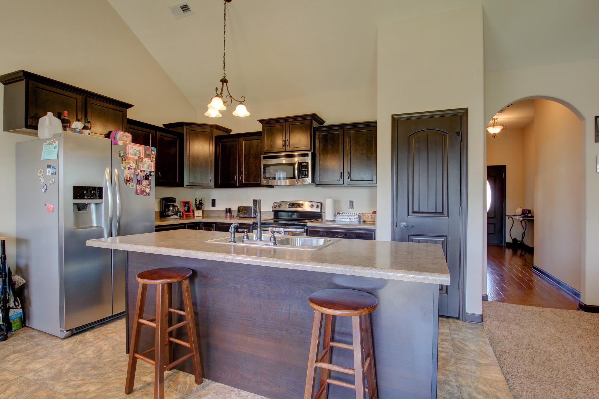 3736 Suiter Road Clarksville, TN 37040 - Photo 5 of 21 a kitchen with stainless steel appliances granite countertop a sink refrigerator and microwave