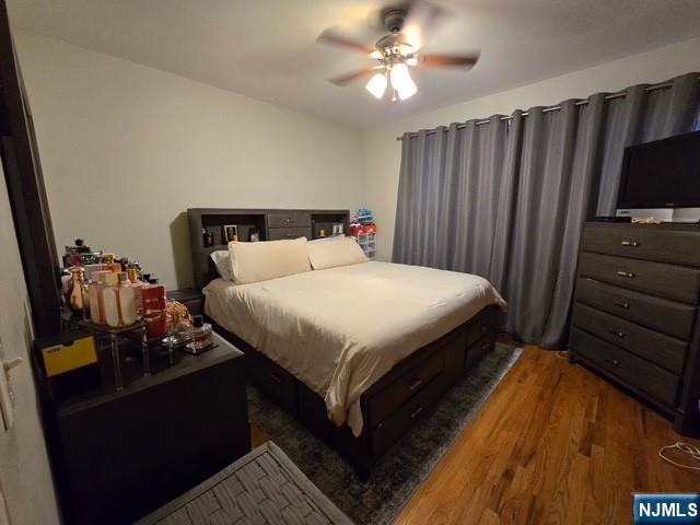 9 Schuyler Court, Unit R2 Kearny, NJ 07032 - Photo 5 of 6 a bedroom with a bed and wooden floor
