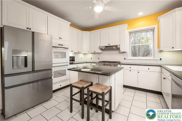 a kitchen with stainless steel appliances a sink a stove and a window