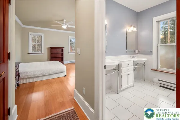 a bedroom with a large bed and a chandelier