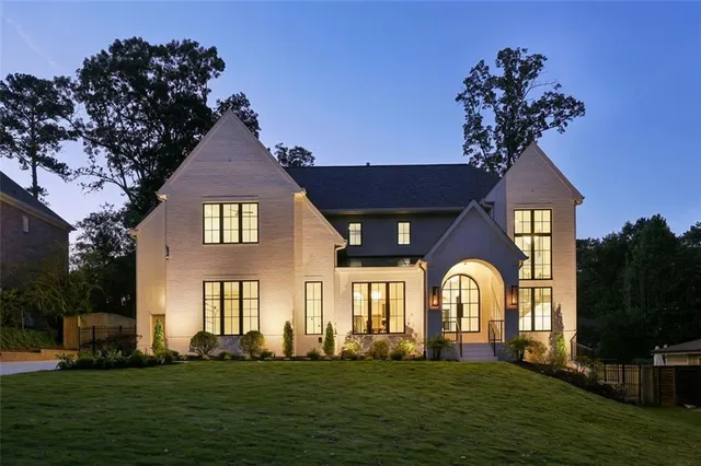 a front view of a house with a garden