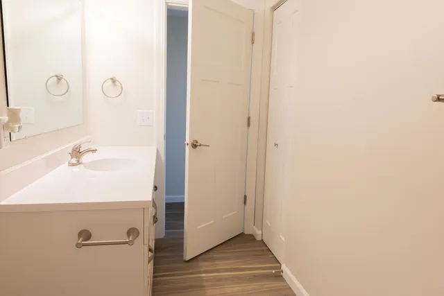 a bathroom with a double vanity sink and a mirror