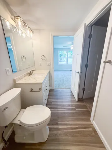 a white toilet sitting next to a bathroom sink