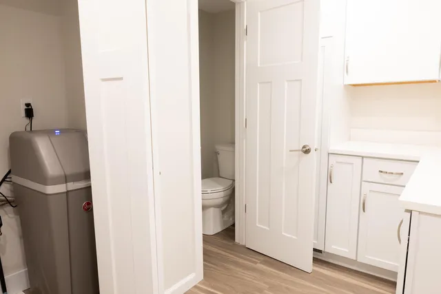 a bathroom with a granite countertop toilet and a shower