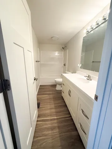 a large white bathroom with a double vanity sink and a mirror