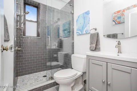 a large bed sitting in a bedroom next to a bathroom