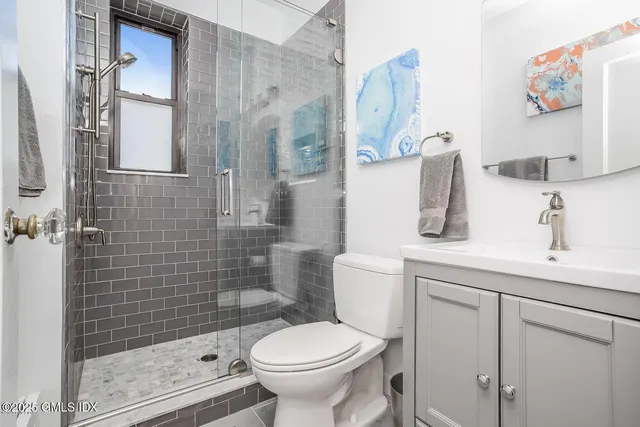 a large bed sitting in a bedroom next to a bathroom