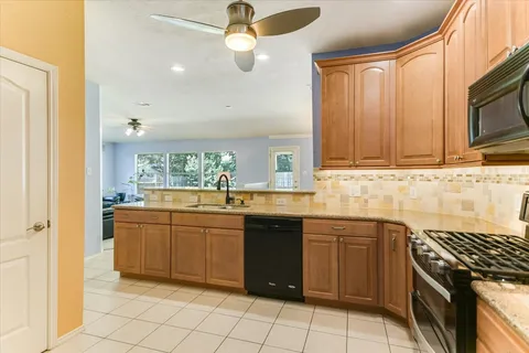 a kitchen with refrigerator and cabinets