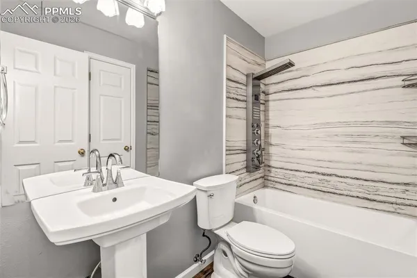 a bathroom with a sink toilet and shower