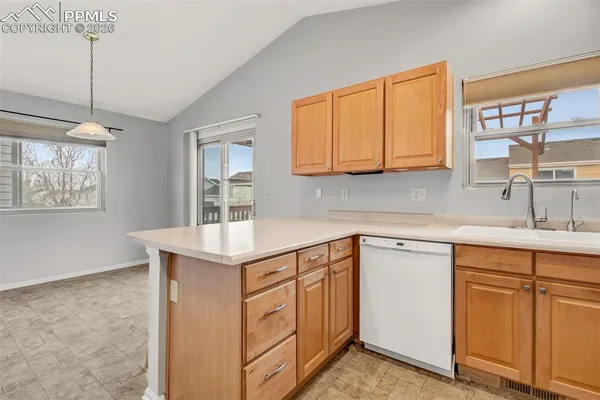 a kitchen with cabinets appliances a sink and a window