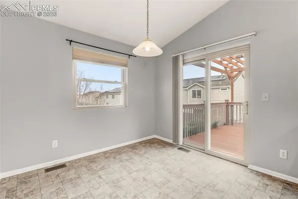 a view of an empty room with glass door
