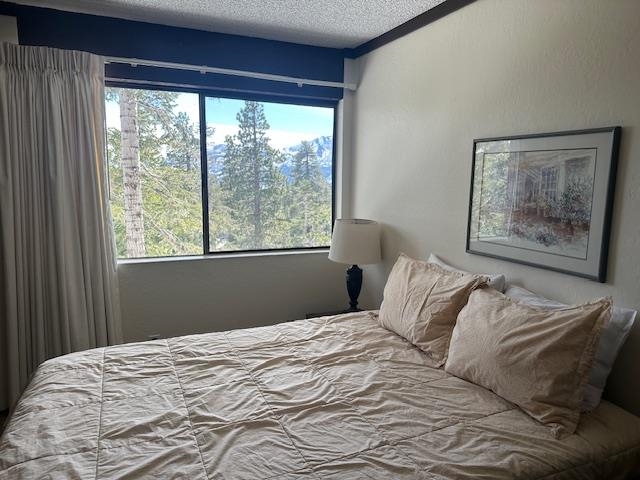 248 Mammoth Slopes, Unit F53 Mammoth Lakes, CA 93546 - Photo 23 of 35 a bedroom with a bed and a large window