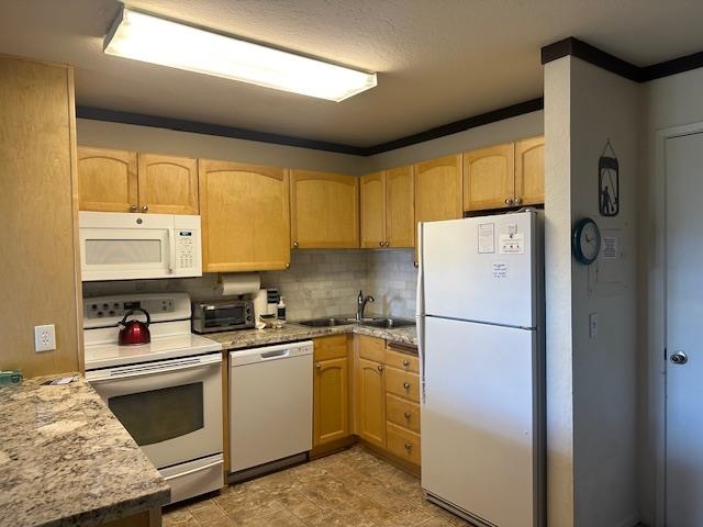 248 Mammoth Slopes, Unit F53 Mammoth Lakes, CA 93546 - Photo 4 of 35 a kitchen with a sink a refrigerator and cabinets
