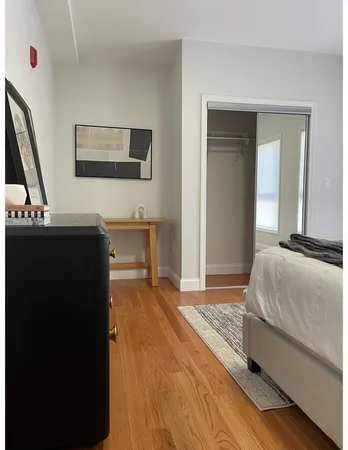 a bedroom with a bed and a desk