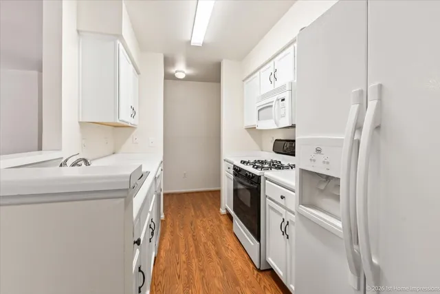 a kitchen with stainless steel appliances a stove a sink and a refrigerator