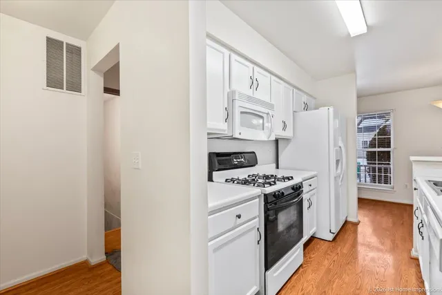 a kitchen with stainless steel appliances a stove and a refrigerator