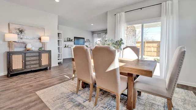 a kitchen with granite countertop a sink a counter top space and living room view