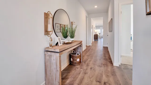 a view of a hallway with wooden floor windows and a wooden floor