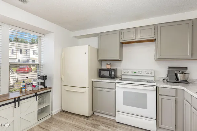 a white refrigerator freezer sitting in a kitchen